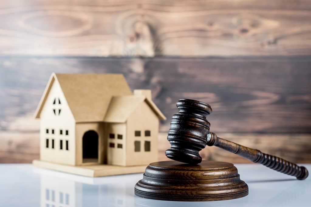 Model house beside an auction gavel